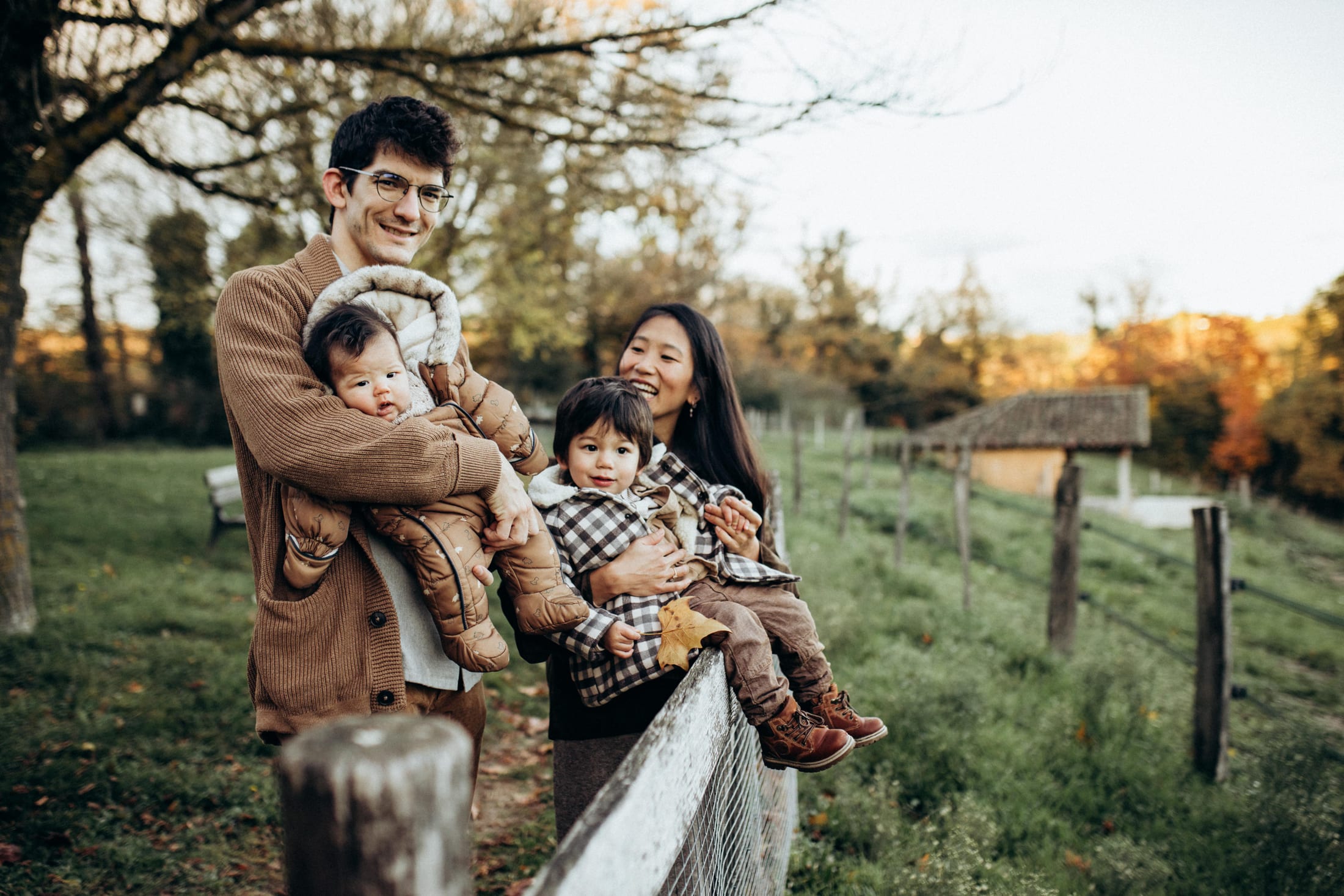 A family gathered in a field, in the warm light of autumn.